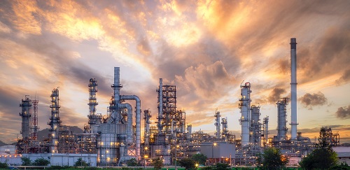 An image of a oil refinery at sunset.
